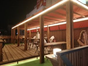 Beautiful outdoor seating area on the top of the building with a view of the dotombori river. at Fahua 法華素食 in Osaka