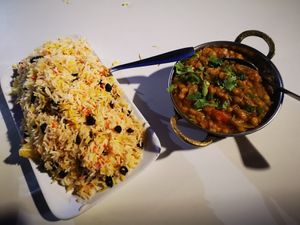 Yellow lentils Dahl, basmatic rice with dried fruits at Jaipur Palace in Sevilla