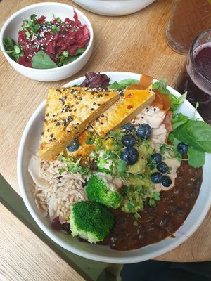 Black bean rice bowl with tofu and kimchi salad on the side at Nude Food in Augsburg