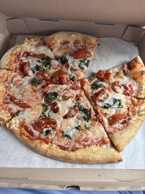 Large vegan pizza with roasted tomatoes and spinach (my husband already took a piece out)  at Mellow Mushroom in Branson