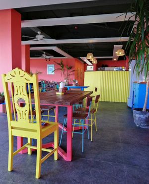 Bold and unique furniture mixing antique table tops with colorful, geometric lines.  at Chido Cafe in Tagbilaran