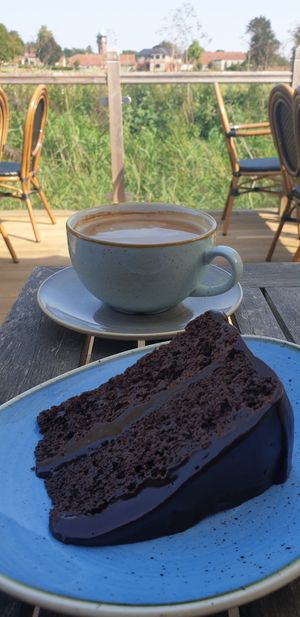 Soya milk Americano & the Devils Fudge cake on the terrace at Lime Kiln Kitchen in Thetford