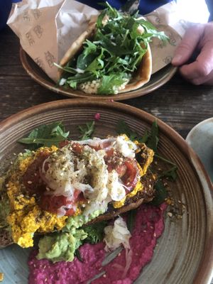 Scrambled tofu, avo’ and beetroot hummus - delicious. Slouvaku in the background with falafel.   at Beach House Cafe in Kaikoura