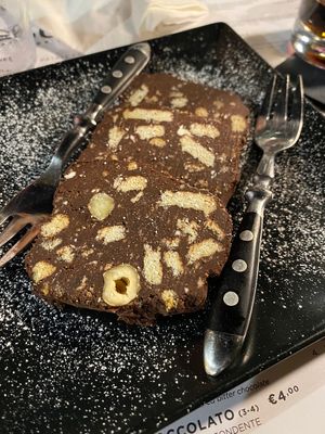Intense chocolate dessert with digestive crackers in side   at Buns in Alghero