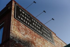 Outside of the building. Historic status building in Lethbridge AB. Ghost images of businesses past beneath the new painted sign.  at Jonny Bean Coffee in Lethbridge