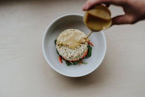The Jonny Bean Glory Bowl (Vegan). Brown rice, shredded local carrots, beets and cucumber on a bed of local lettuce with a tamari and tahini dressing and toasted almonds.  at Jonny Bean Coffee in Lethbridge
