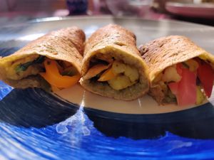 'Green Mung Veggie Wrap' is gluten free & vegan,  made with the mung sprouts. Filled with gently spiced up potatoes & steamed veggies with coriander & tamarind-jaggery chutneys! at AhimsaGram in Jaipur