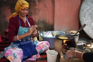 Santosh ji making corn roti with mustard greens.  at AhimsaGram in Jaipur