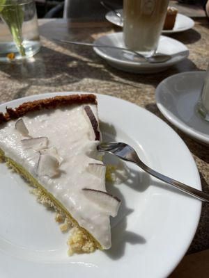 Lemon and coconut tarte, poppy seed cake (background) and latte macchiato   at Der Kaffeekocher & Meer in Sankt Peter-ording