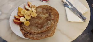 Brunch: Pancakes with peach, banana, syrup, and cinnamon. at Mela Canela in Sintra