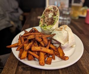 Huge wrap and really good sweet potato fries at Rise Above Pizza & Wings in Hamilton