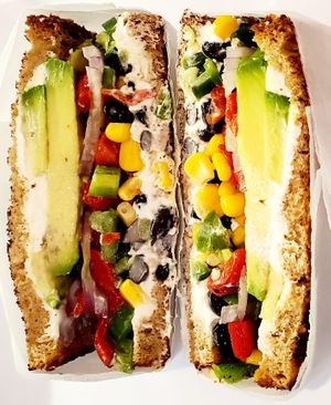 Mexi Vegan Sandwich {Avocado, Black beans, Corn, Jalapeno, Black Beans, Red Onion, Plain Tofu Cream Cheese. Served on sliced 7-grain bread. at Bagel Point in Brooklyn