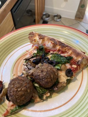 Vegan pizza slice at The Secret Stash in Crested Butte