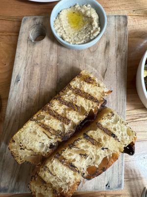 Grilled focaccia with roasted eggplant spread   at Somebody People in Denver