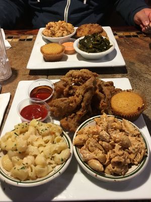 V fish (top) served with collard greens, “seafood” pasta and cornbread. V chick’n (bottom) served with maple syrup to dip, Mac and “cheese” and “seafood” pasta   at Go Vegan Philly in Wilmington