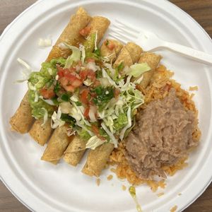 potato taquitos with beans and rice and toppings (party pack catering order)  at El Tianguis in San Diego