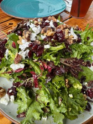 Vegan version of The Privateer Salad: Mixed greens, radicchio, spinach, Privateer vinaigrette, vegan cheese, candied walnuts, dried cranberries at The Privateer in Oceanside