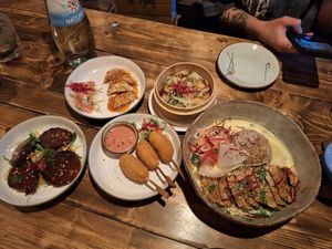 Caramel sauce over dumplings, braised beef, prawn sticks, peanut mock duck at Element Five in Berlin