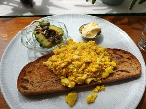 Tofu scramble on sourdough bread, avocados and vegan butter at Tiffin Cafe in Lisbon