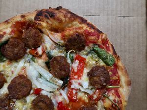 Aunt Connie - Red Sauce, Vegan Sausage, Onion, Spinach, Giardiniera, Goat Horn Peppers, Vegan Cheese  at Gianni's Pizza in Oceanside