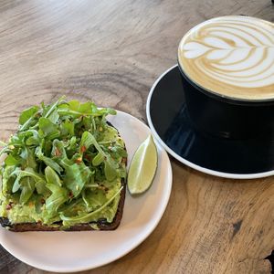 Avocado toast and a oat milk latte  at Captain + Stoker in Monterey