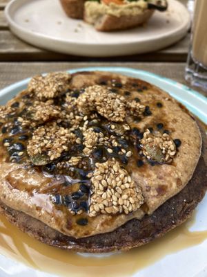 their pancake with nut butter and roasted seed granola on top - SO DELICIOUS!  at Manna Porto in Porto