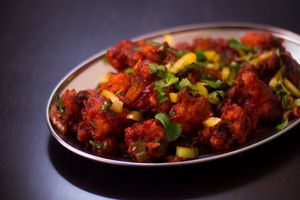 Gobi Manchurian - Florets of cauliflower deep fried and sauteed in manchurian sauce and garnished with spring onions at Krishna Vilas in Utrecht