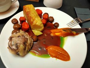 Potato gratin, carrot, mushrooms, cashew cheese, vegan gravy sauce, parsley and chives oil at Bo No Bo Vegan in Olsztyn