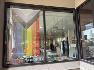 Gay pride flag and “ceasefire” signn show their at Angelhearts Donuts in Ithaca