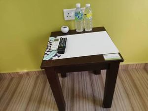 side table in the room at Nature Vegetarian Guest House in Malacca