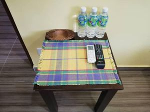 side table in the room at Nature Vegetarian Guest House in Malacca