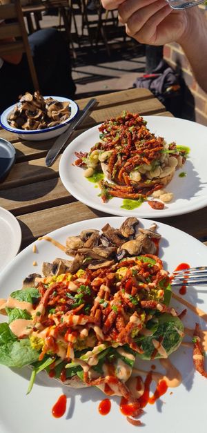 Scrambled tofu on granary toast and spinach with 'bacon' bits covered in spicy siracha at T @ the dials in Brighton