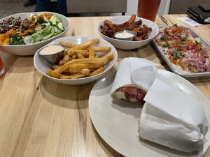 Strawberry lemonade, iced tea, Baja fish tacos, kimchi beef bowl, California wrap, fries, sweet potato fries, with chipotle aioli, Belgian chocolate cake, carrot cake  at Veggie Grill by Next Level in Cambridge