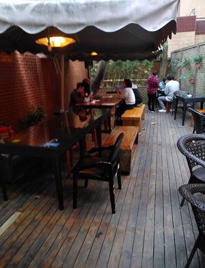 Outdoor seating  at GōngDé Lín - Godly - Huanghe Rd in Shanghai
