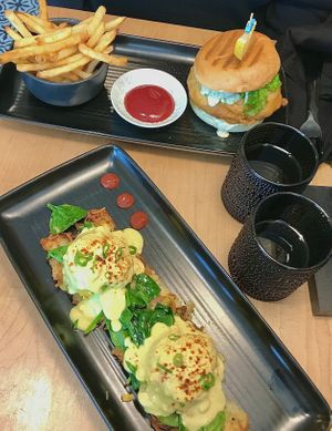 Eggs benedict and fillet of fish sandwich with fries    at Down 2 Earth in Langley