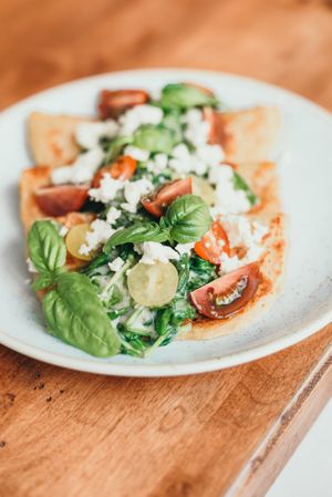 Garbanzo French crepes with spinach, tomatoes and tarragon lemon oat cream sauce. Part of the new brunch menu! at Down 2 Earth in Langley
