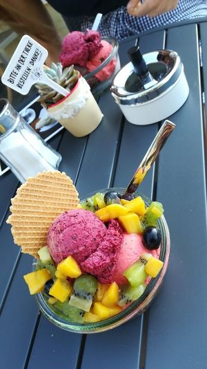 Blueberry & strawberry ice cream with grapes, mango and kiwi fruit as topping.  at Eismanufaktur Soest in Soest