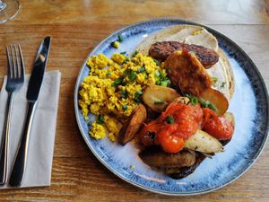 Tofu scramble with tempeh bacon, vine tomatos, potatoes and sourdough bread at Greens & Co in Galway