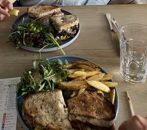 Top plate: chickie sandwich with side salad; bottom plate: Philly sandwich with salad and fries  at Greens & Co in Galway