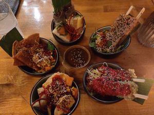 Top: summer rolls. Right top: peanut tofu sticks. Right bottom: green tofu sticks. Left bottom: wonton. Left top: sweet potato pancakes at Vegan House - Alaunstraße in Dresden
