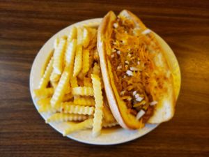 Vegan chili dog.  A vegan sausage dog smothered w/ our vegan chili, red onions and cheese.  As pictured, the bun contains egg, so strict vegans should request sourdough toast.  :) at Kelcy's in Tehachapi