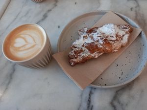 Capuccino and almond croissant at Mica Coffeebar in Haarlem