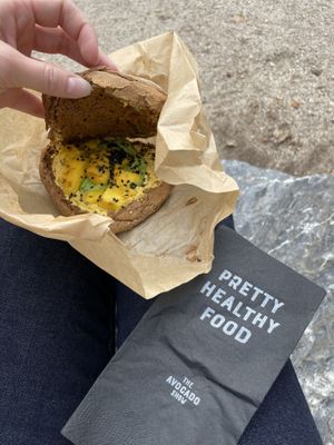 Mango tango sandwich with mango, avocado, curry hummus and sesame seeds served on brown multigrain bread  at The Avocado Show - To Go in Amsterdam