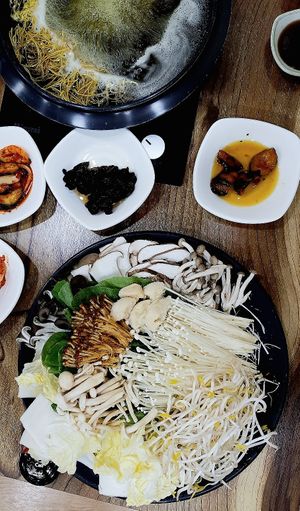 Plate of assorted mushrooms and plant-based broth at Mushroom Shabu Shabu 버섯샤브샤브 in Seogwipo