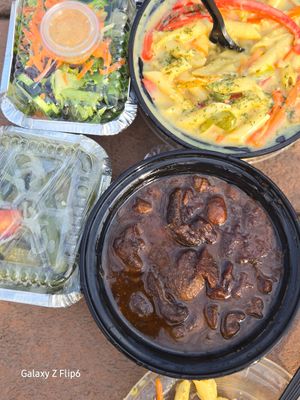 Mushroom oxtail, sautéed okra, rasta pasta, salad at Toma-Tis in Elmont