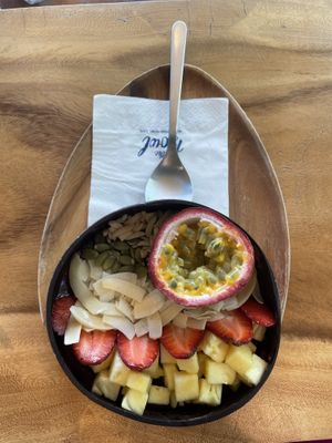 Customised (build your own bowl) version: frozen berry mix base and 6 toppings by own choice. Here are: passion fruit, strawberry, pineapple, coconut chips, pumpkin seeds, almond.  at Hosay Bowl in Phuket