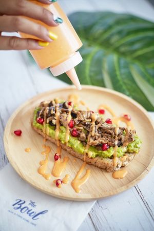 VEGAN Avocado toast 
(wholewheat bread, avocado, meaty mushroom, vegan homemade Sriracha mayo, pomegranate)  at Hosay Bowl in Phuket