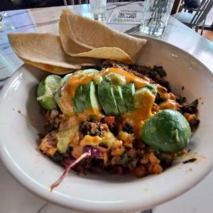 Mexican Hash: tofu scramble, soyrizo, grilled potatoes, onions, red peppers, black beans, Kale greens, arugula, avo slices, corn tortillas 😋 at Vegan Avenue in San Antonio