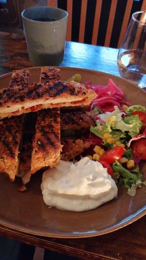 Grilled sandwich with vegan mozzarella, smoked tofu, sundried tomatoes and vegan aioli and salad :) at Vegano's in Uppsala