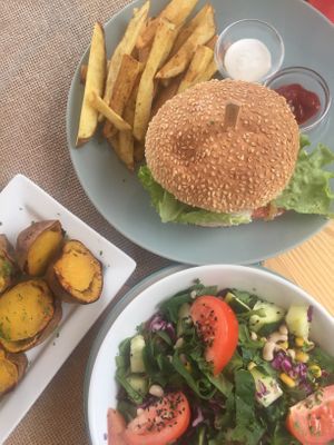 A kind burger meal, baked sweet potato and salad. at Mundo Vegan - Vegan World in Funchal